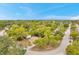 Beautiful aerial view of a charming single-story home surrounded by lush greenery in a peaceful neighborhood at 13102 Wagner Dr, Hudson, FL 34667