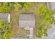 An aerial view shows a well-maintained roof and a lush, tree-filled neighborhood at 13102 Wagner Dr, Hudson, FL 34667