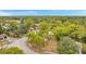 Aerial view of a residential area featuring homes surrounded by lush greenery and tree coverage at 13102 Wagner Dr, Hudson, FL 34667