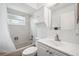Bright bathroom with tub/shower, white vanity and tile at 13102 Wagner Dr, Hudson, FL 34667