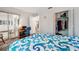 This bedroom features a blue bedspread, closet, and natural light at 13102 Wagner Dr, Hudson, FL 34667