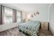 Relaxing bedroom includes wood-look floors, coastal decor, two windows and closet with louvered doors at 13102 Wagner Dr, Hudson, FL 34667