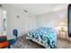 Cozy bedroom features white walls, wood-look floors, a blue quilt and closet with louvered doors at 13102 Wagner Dr, Hudson, FL 34667