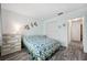 Bright bedroom featuring two windows, wood-look floors, coastal decor and closet with louvered doors at 13102 Wagner Dr, Hudson, FL 34667