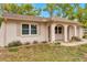 Charming single-story home featuring arched entry and neutral paint with mature landscaping at 13102 Wagner Dr, Hudson, FL 34667