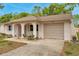 Charming single-story home featuring a one car garage, arched entry and neutral paint at 13102 Wagner Dr, Hudson, FL 34667