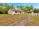 Well-maintained home with a classic design, surrounded by mature trees and a spacious front lawn at 13102 Wagner Dr, Hudson, FL 34667