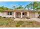 Charming single-story home featuring a well-manicured lawn, arched entryway, and attached single car garage at 13102 Wagner Dr, Hudson, FL 34667