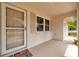 Covered front porch with view of the front yard and garage at 13102 Wagner Dr, Hudson, FL 34667