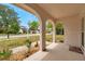 Covered front porch with elegant archways and view of the street at 13102 Wagner Dr, Hudson, FL 34667