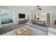 Bright living room boasts a modern interior, an adjacent bedroom view, and natural light from the french doors at 13102 Wagner Dr, Hudson, FL 34667