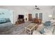Cozy living room featuring wood-look flooring and a view into the dining area at 13102 Wagner Dr, Hudson, FL 34667