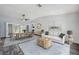 Bright living room boasts a modern interior, a long dining table, and natural light from the french doors at 13102 Wagner Dr, Hudson, FL 34667