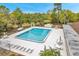 Aerial view of the neighborhood pool with several lounge chairs for relaxing in the sun at 13102 Wagner Dr, Hudson, FL 34667