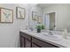 Bathroom with double sinks, granite countertops, and framed art at 1707 Tahitian Sunrise Dr, Plant City, FL 33565