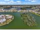 Picturesque view of waterfront homes surrounding a lush, uninhabited island in a canal community at 1804 Bunker Hill Dr, Sun City Center, FL 33573