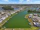 Scenic view of waterfront community with canal homes, boats, docks, and tropical landscaping at 1804 Bunker Hill Dr, Sun City Center, FL 33573