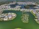 Picturesque view of waterfront homes surrounding a lush, uninhabited island in a canal community at 1804 Bunker Hill Dr, Sun City Center, FL 33573