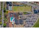 Top-down aerial view of community center with a pool, greens, and parking lots at 1804 Bunker Hill Dr, Sun City Center, FL 33573