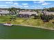 Waterfront home with a screened lanai, lush lawn, and private dock perfect for relaxing by the water at 1804 Bunker Hill Dr, Sun City Center, FL 33573