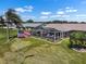 Backyard with a screened-in lanai overlooking a lush lawn and waterfront at 1804 Bunker Hill Dr, Sun City Center, FL 33573