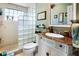 Elegant bathroom with custom vanity, marble countertop, and a glass block shower at 1804 Bunker Hill Dr, Sun City Center, FL 33573