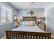Bedroom features a wooden sleigh bed, neutral walls, and plantation shutters for natural light at 1804 Bunker Hill Dr, Sun City Center, FL 33573
