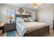 Cozy bedroom featuring a large bed, beach decor, and natural light from the windows at 1804 Bunker Hill Dr, Sun City Center, FL 33573