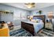 Charming bedroom with blue walls, ceiling fan, and a wooden sleigh bed with a starfish-themed rug at 1804 Bunker Hill Dr, Sun City Center, FL 33573