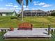 Charming dock area featuring a comfortable bench, plants, and scenic views of the backyard and enclosed patio at 1804 Bunker Hill Dr, Sun City Center, FL 33573