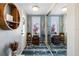 Inviting foyer with mirrored closet doors, decorative rug, and natural light at 1804 Bunker Hill Dr, Sun City Center, FL 33573