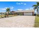 Beautiful home with paved driveway, attached garage, colorful landscaping, and well-manicured lawn at 1804 Bunker Hill Dr, Sun City Center, FL 33573