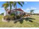 Lush landscaping and mature palm trees accent this inviting single-story home at 1804 Bunker Hill Dr, Sun City Center, FL 33573