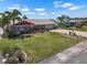 Well-maintained home with a lush lawn, professional landscaping, and a brick driveway at 1804 Bunker Hill Dr, Sun City Center, FL 33573