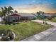Charming single-story home with lush landscaping, paver driveway, and decorative exterior accents at 1804 Bunker Hill Dr, Sun City Center, FL 33573