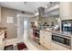 Bright kitchen with stainless steel appliances, tile flooring, and modern cabinetry at 1804 Bunker Hill Dr, Sun City Center, FL 33573