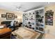Gathering room features a comfortable seating area with a white built-in bookcase and a large rug at 1804 Bunker Hill Dr, Sun City Center, FL 33573