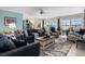 Bright living room with plush seating, ceiling fan, and views of the lake at 1804 Bunker Hill Dr, Sun City Center, FL 33573
