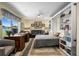 Beautiful living room featuring a built-in bookcase and a bed, perfect for guests at 1804 Bunker Hill Dr, Sun City Center, FL 33573