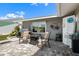 Outdoor patio with brick pavers, comfortable seating, and views of the beautifully landscaped backyard at 1804 Bunker Hill Dr, Sun City Center, FL 33573