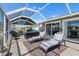 Enclosed patio offers a serene space with comfortable seating and beautiful views of the lush surroundings at 1804 Bunker Hill Dr, Sun City Center, FL 33573