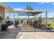 Enclosed patio with stylish seating, a bar, and a serene waterfront view at 1804 Bunker Hill Dr, Sun City Center, FL 33573
