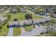 Aerial view of townhomes, manicured lawns, and mature trees in a quiet community at 18836 Summersong Dr, Hudson, FL 34667
