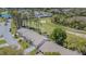 Aerial view of homes along a golf course featuring mature trees, sand traps, and green fairways at 18836 Summersong Dr, Hudson, FL 34667
