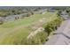 Aerial view of a golf course alongside a highway, featuring sand traps and well-manicured greens at 18836 Summersong Dr, Hudson, FL 34667