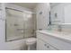 Clean bathroom with a shower-tub combo, a large countertop and vanity space, and a modern mirror at 18836 Summersong Dr, Hudson, FL 34667