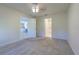 Spacious bedroom with plush carpet, offering doorway views of the living area and the bathroom at 18836 Summersong Dr, Hudson, FL 34667