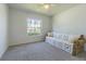 Bright bedroom with a large window that allows natural light to fill the room, complete with a comfortable sofa at 18836 Summersong Dr, Hudson, FL 34667