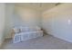 Cozy bedroom features soft carpet and a sofa with a decorative quilt, creating a comfortable and inviting space at 18836 Summersong Dr, Hudson, FL 34667