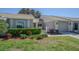 Charming single-story home with manicured lawn, mature landscaping, and a two-car garage at 18836 Summersong Dr, Hudson, FL 34667